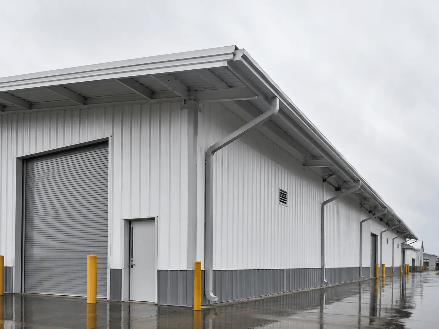 Warehouse building with downspouts running to ground level