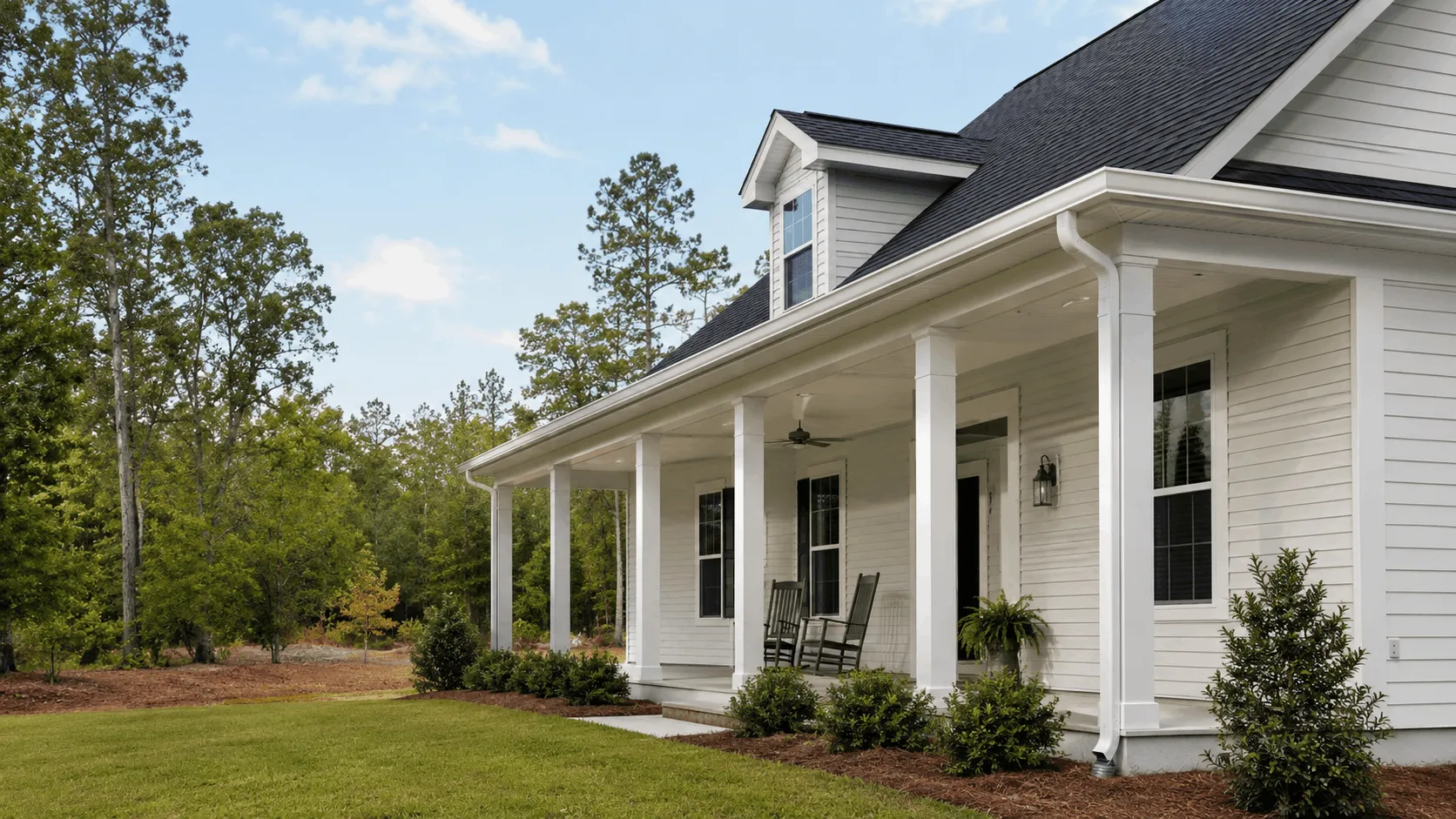 Greenwood home with an upper roof above a lower porch roof