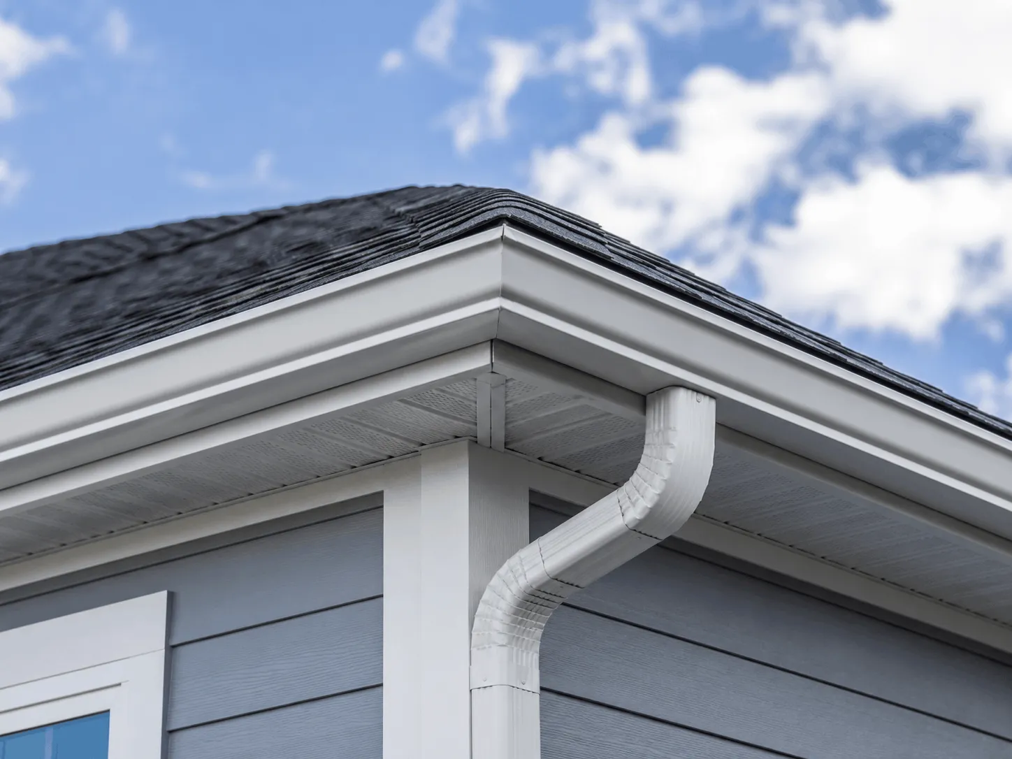Downspout elbow and gutter corner on a home